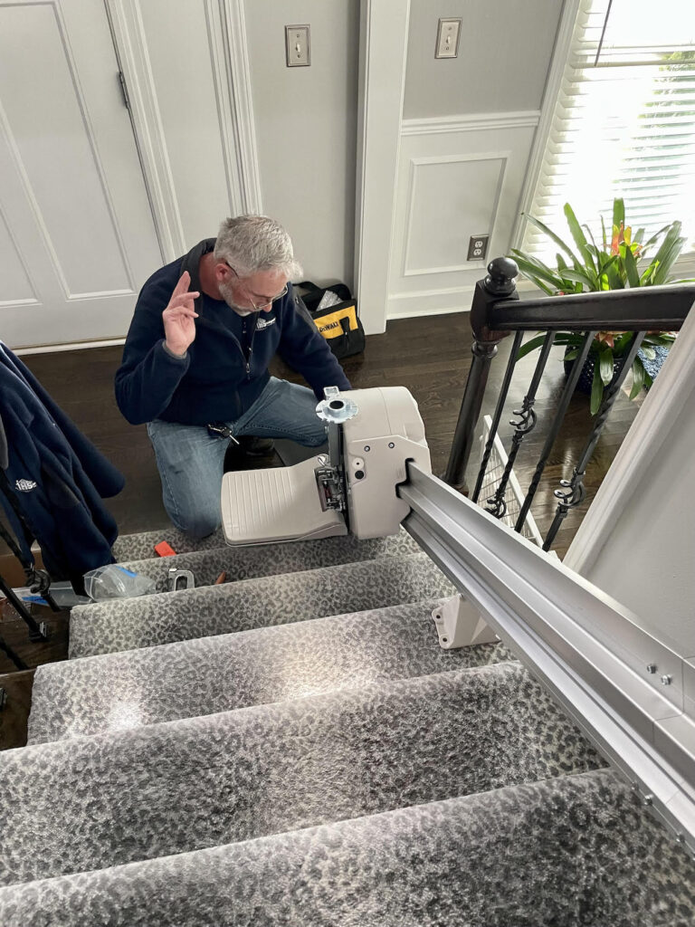 man repairing a stair lift